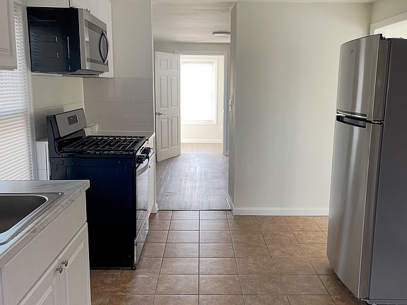 kitchen facing living room and extra room
