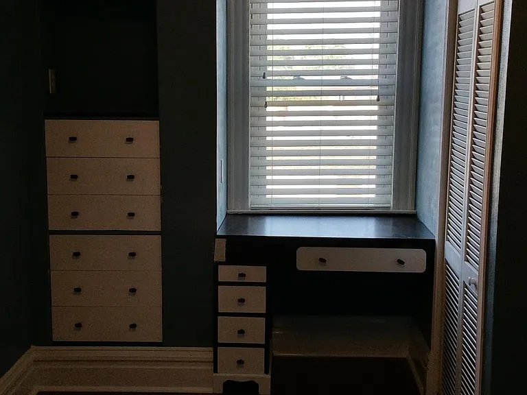 Since the bedroom is a bit smaller - it features a built in dresser and desk overlooking the window! The furnace and air handler for the HVAC equipment are inside the vented doors next to the desk - the system is energy efficient and very quiet.