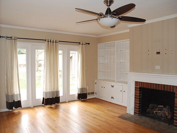 living room with fireplace and built in shelves