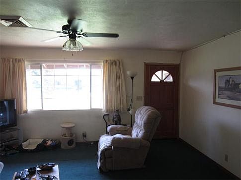 Front door opens to living room area of home.