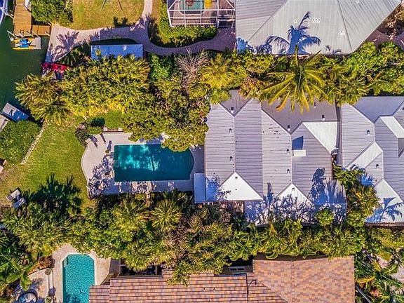 Aerial of the house showing the pool and the western exposure on Nettie Bayou. The dock has two floating pontoons perfect for la