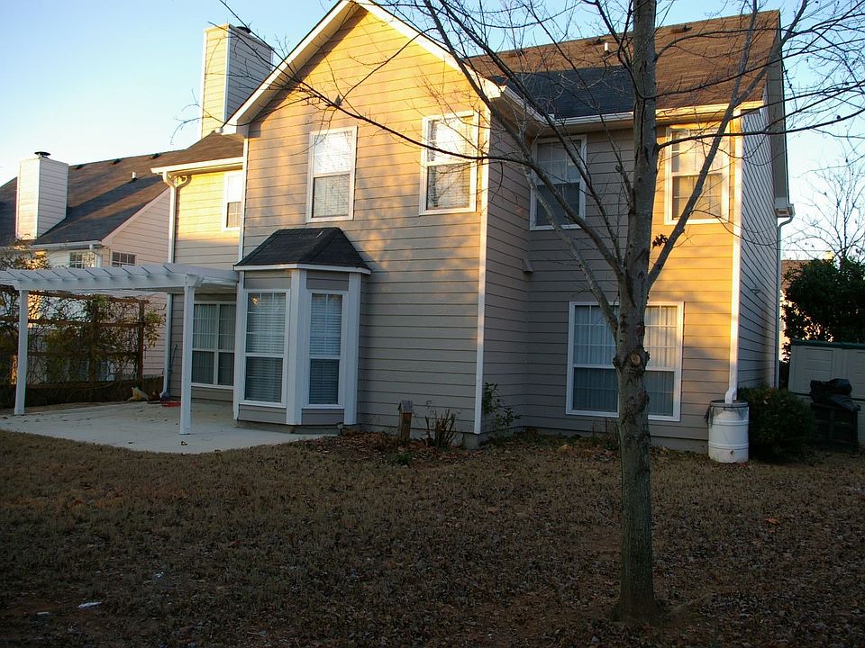 large private back yard with concrete and stone patio - Covered with arbor