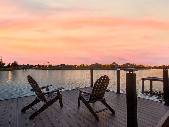 Don't just imagine this paradise, come live it right in the heart of Cypress! Unwind after a long day with gorgeous sunset views over the lake from you swim deck.