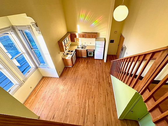 Loft overlooking view of the kitchen and dining area below.