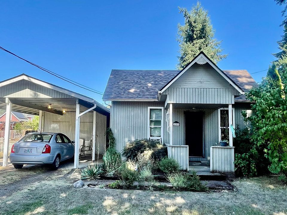 Large front yard with covered carport and storage locker