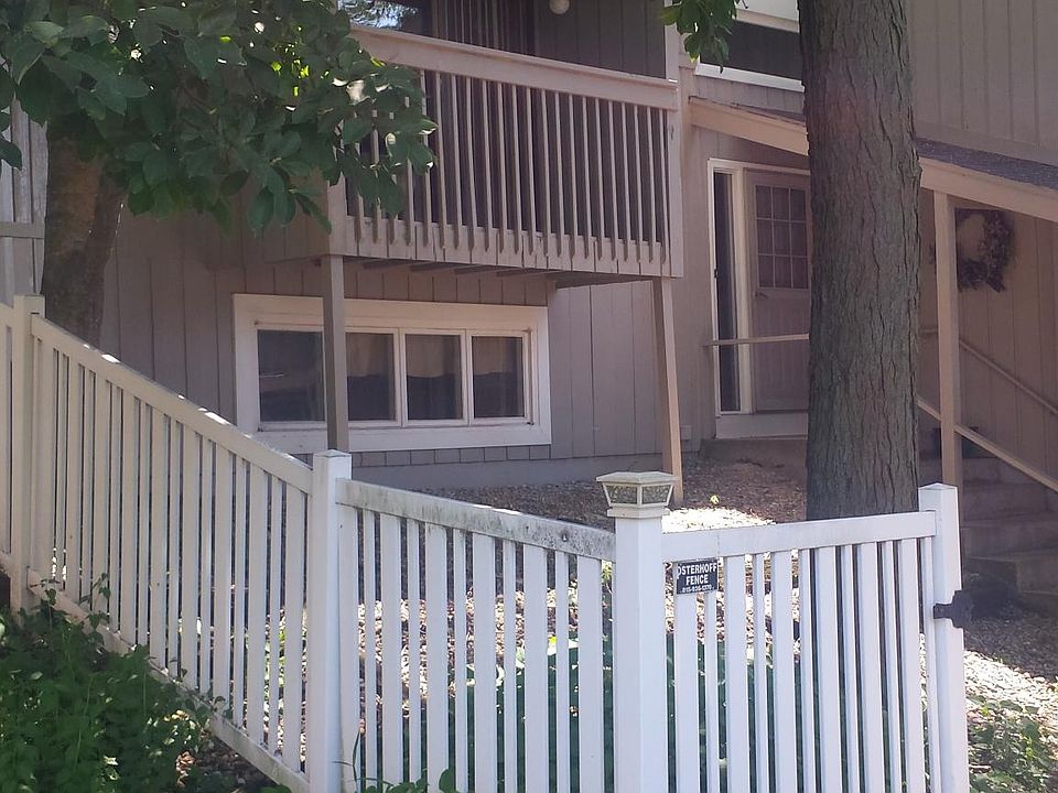 Entrance to duplex. You can see upstairs deck that is off living room. Lower windows are in the downstairs family room.