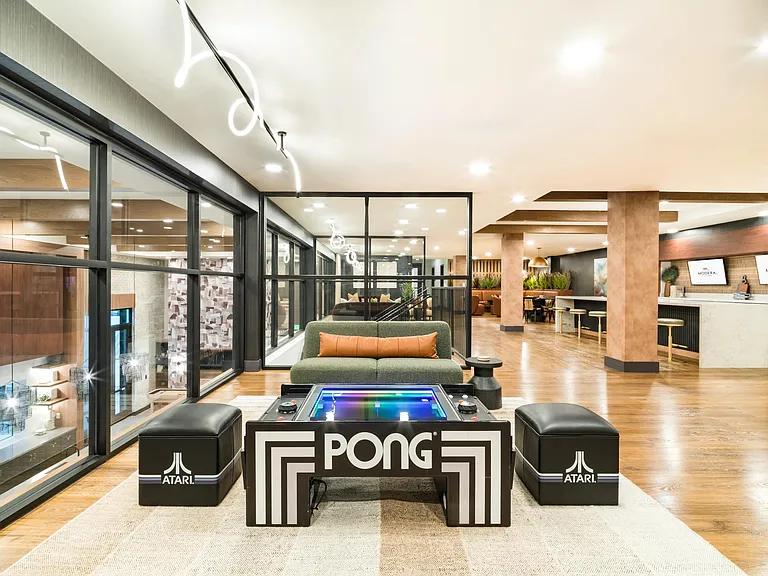 A stylish indoor lounge at Modera Higley Commons, where curated amenities and playful details create a welcoming place to unwind and connect.