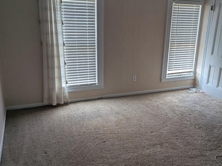 Master bedroom located on the second floor is carpeted with two front windows. Has small closet. Bedroom size: 13 x 12. Room painted in neutral color.