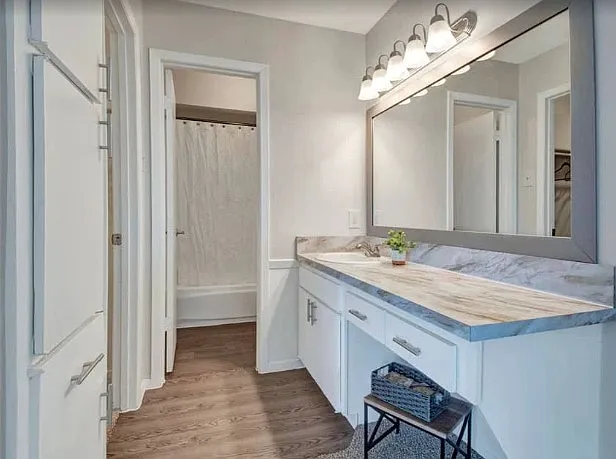 Updated vanity with ample storage and bright lighting