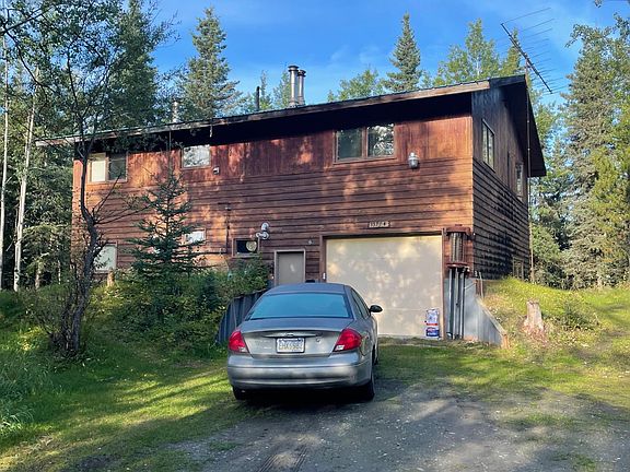 View from the driveway shows the garage entrance
