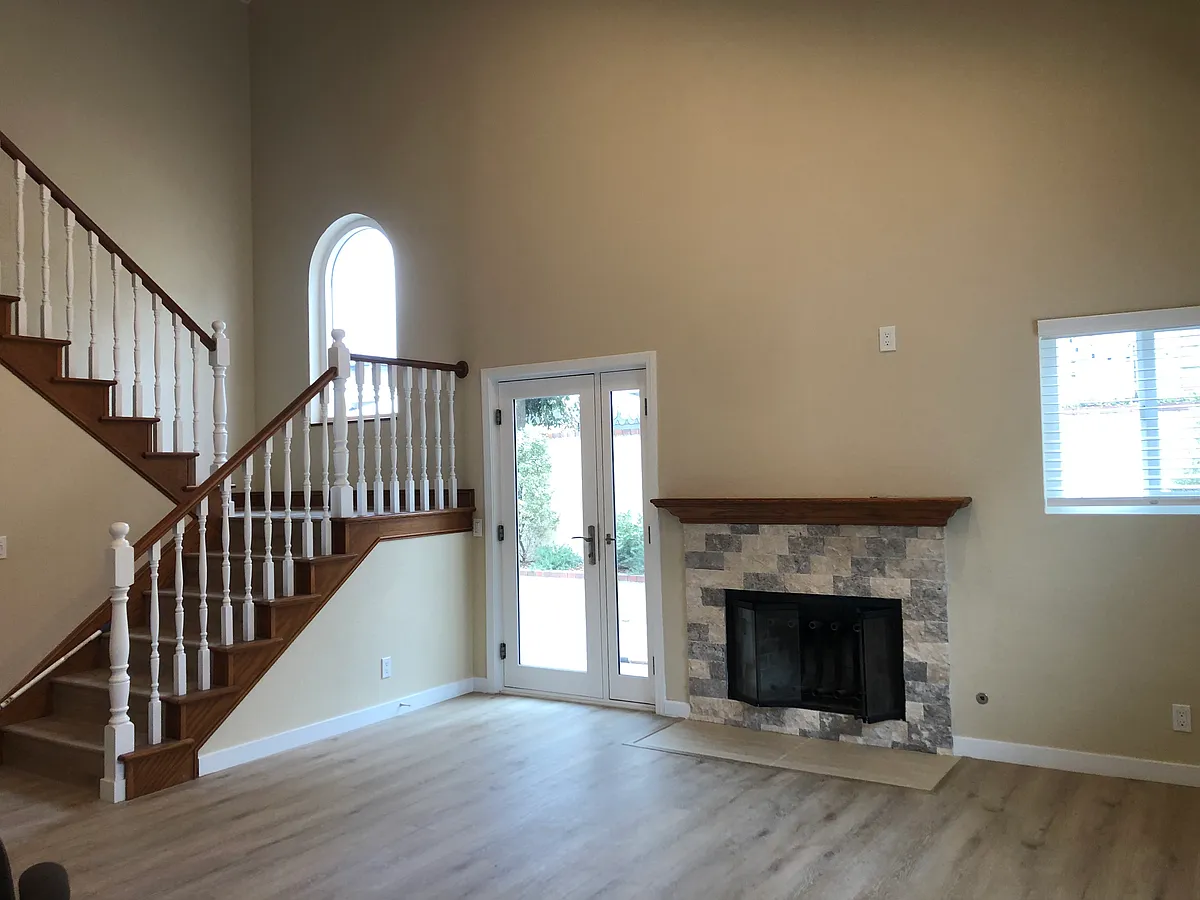 Great room with door onto patio, fireplace and stairs. - 2005 Warfield Ave #B