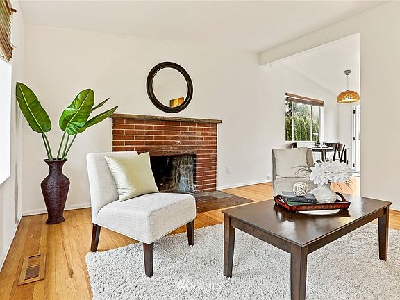 Main floor living room fireplace; enjoy cozy nights in. 7714 18th Ave SW, Seattle, WA 98106 - NWMLS# 1870781