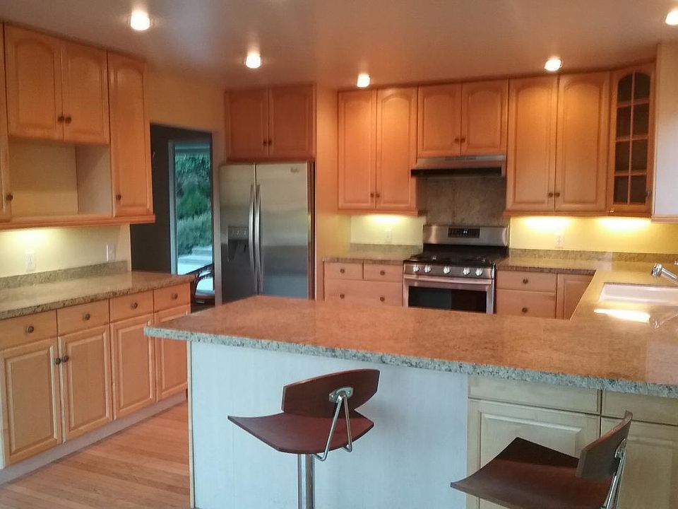 Kitchen with gas stove and SS appliances granite countertops and loads of storage.