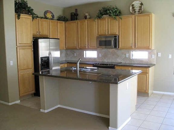 Open kitchen with granite slab counters