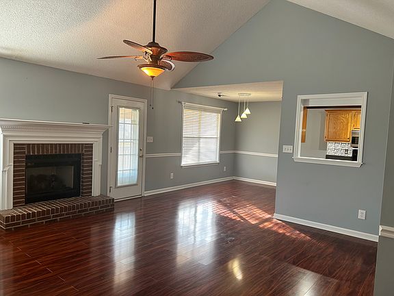 Spacious living room featuring vaulted ceilings and beautiful gas fireplace