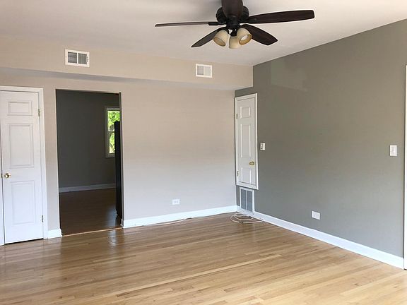 Living Room 19' x 13' - View is looking towards the kitchen. Small cropped door is where the HVAC furnace is located. Door left of the kitchen entrance is the hallway closet.