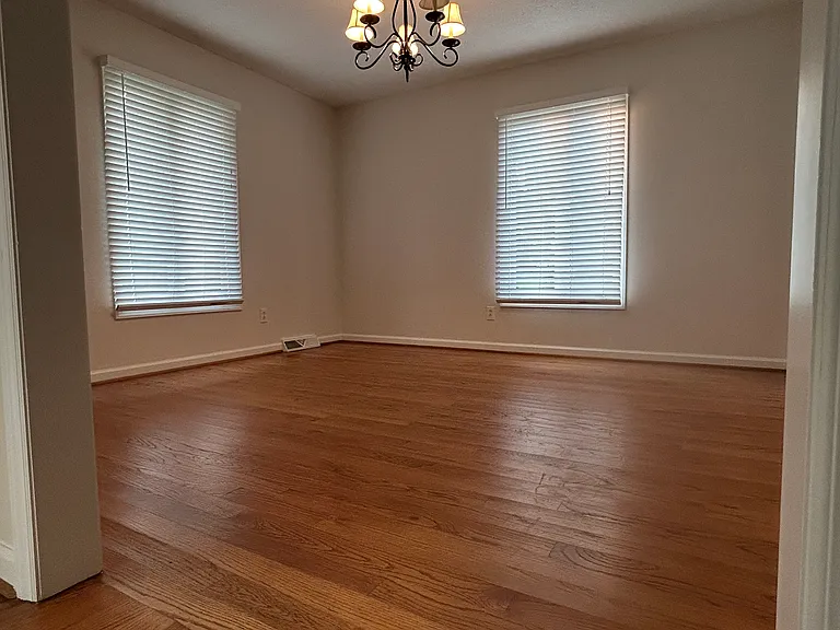 Dinning room with hardwood floor, fresh paint, 2 in faux wood blinds