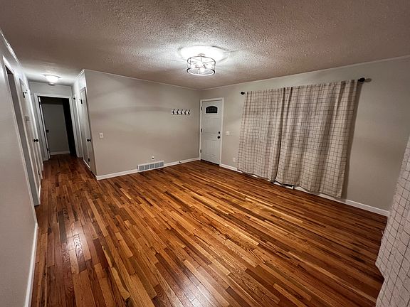 Living room with newly refinished hardwood floors.
