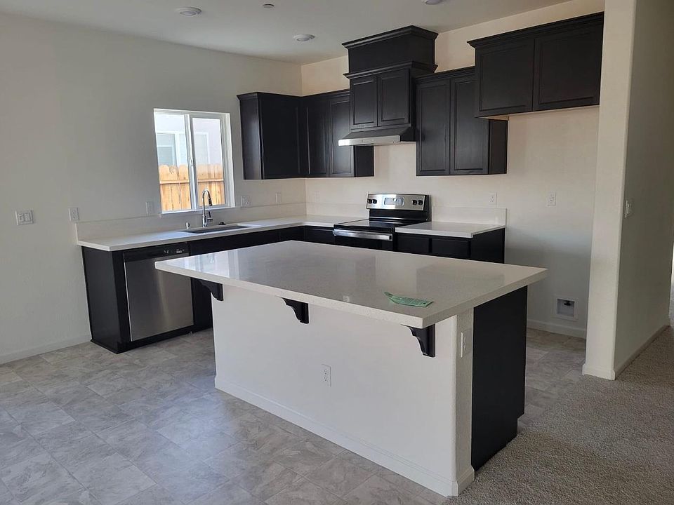 upgraded kitchen with mocha colored cabinets