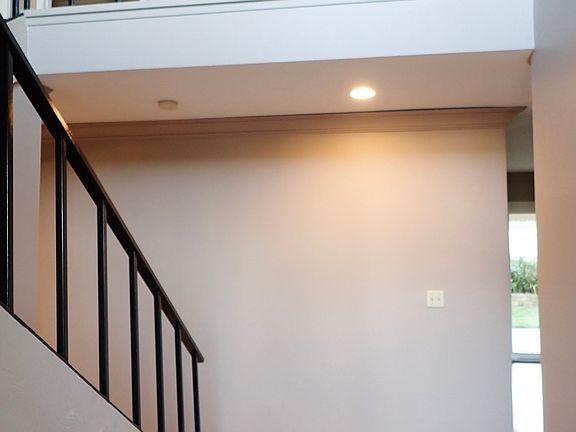 Foyer with staircase on left and upstairs landing
