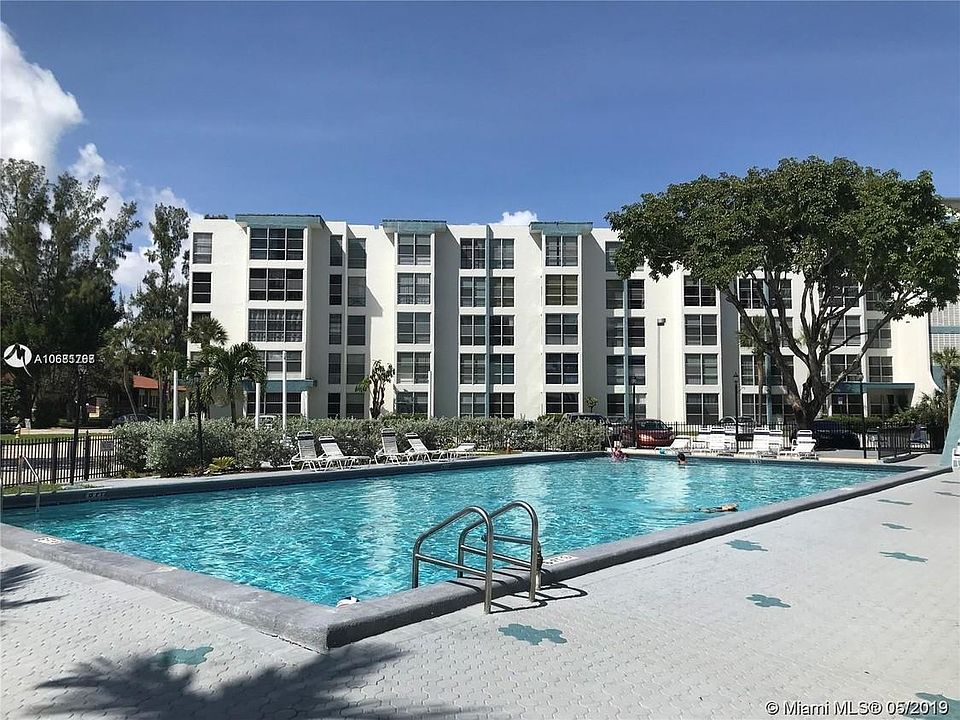 Community Pool in front of Condo Bldg. with chairs, tables and lounges. Includes community meeting room, private bathrooms and shower, exercise room, and large covered sitting dining area