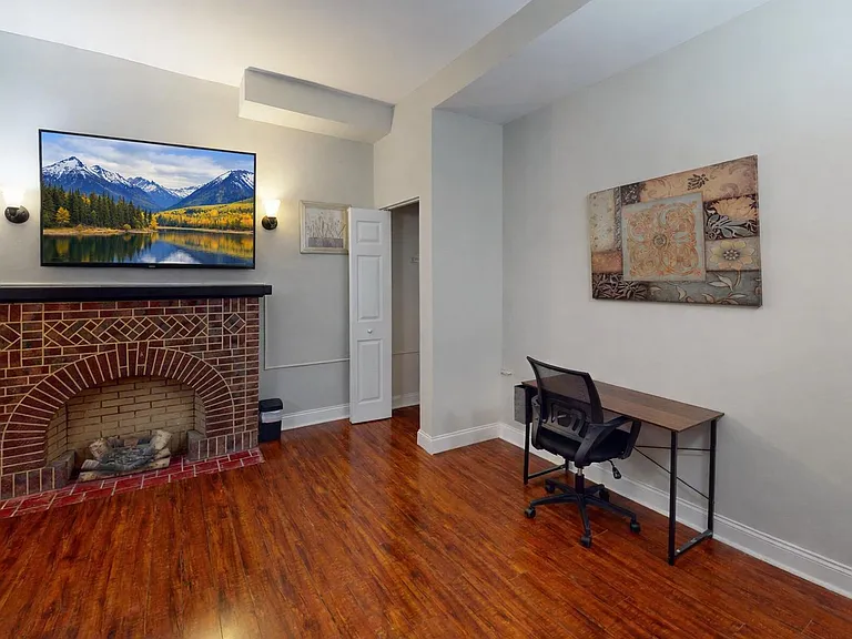 Large room with a closed fireplace, double window for lighting and closet space for easy access storage.