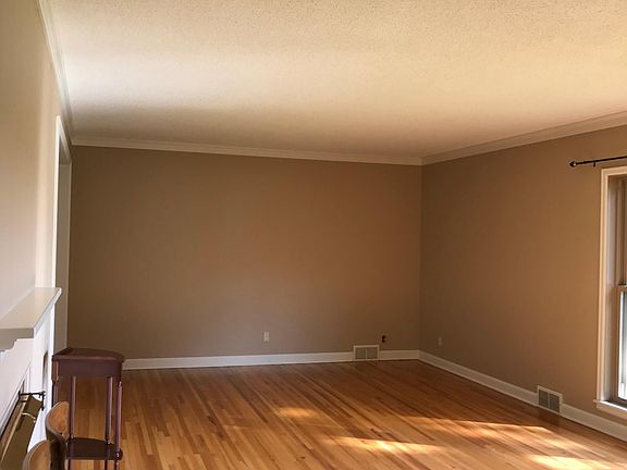 View of living room from the entrance hallway (on the left). This space nicely accommodates an office space and living room space.