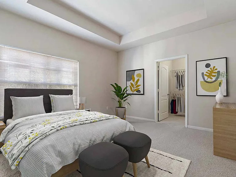 Bedroom with plush carpeting and spacious closet