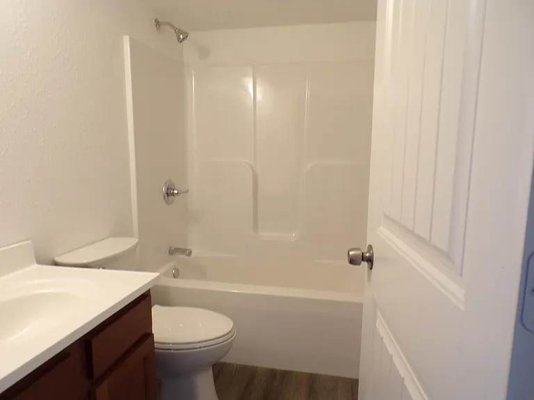 Bathroom with upgraded carriage doors throughout. HE toilet with soft close lid