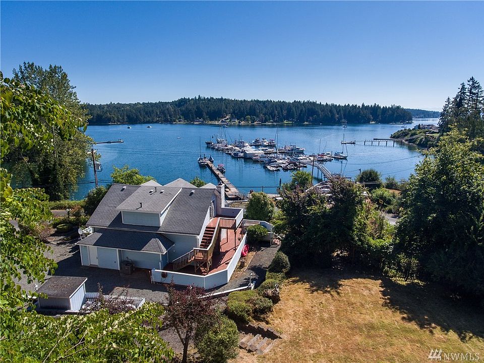 This historic home is perched upon a stunning .5+ acre lot, overlooking the Longbranch Marina and Filucy Bay.