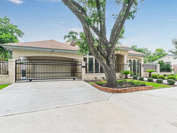 Automatic gated entry to porte cochere and two car oversized garage. Extra driveway parking and circular driveway