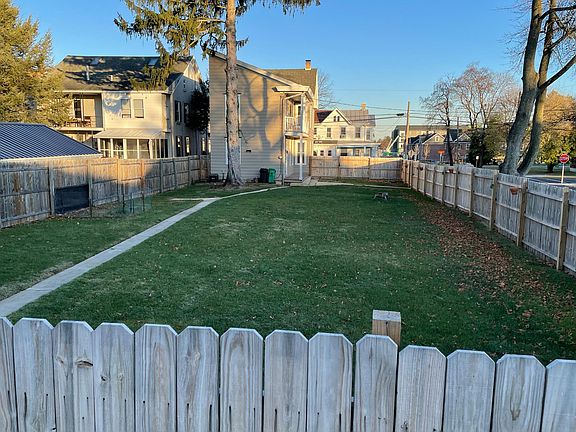 back yard; picture taken from off-street parking (car pad) outside fence