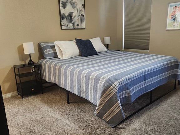 Spacious primary suite with king bed, USB charging, and ensuite bath.