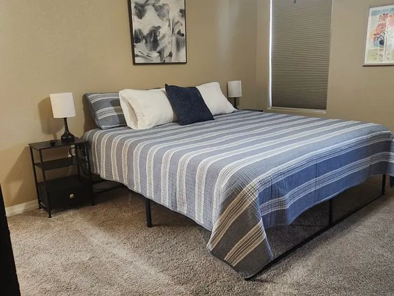 Spacious primary suite with king bed, USB charging, and ensuite bath.
