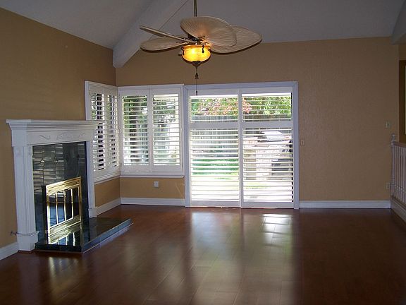 Family room w/ woodburning fireplace, hardwood floors and wet bar