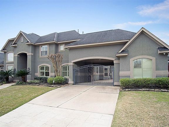 This home offers a 3 car garage with wrought iron gated driveway and porte-cochere.