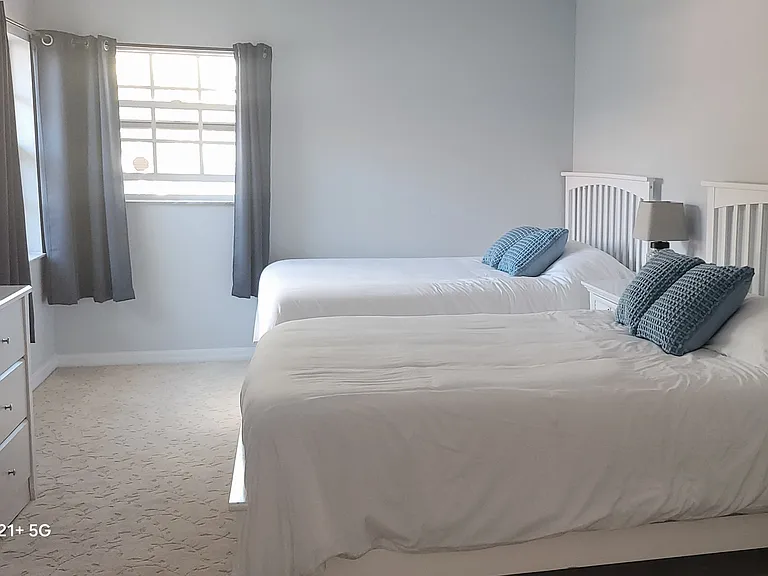 Guest bedroom features two queen beds, perfect for friends, kids, or visiting family.