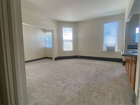 Main living room with a nook for office, great natural light and new air conditioner unit.