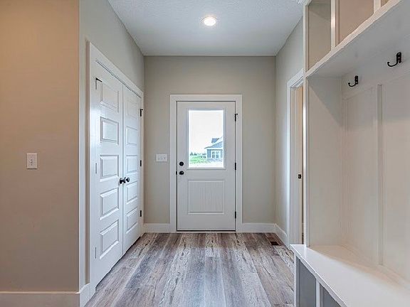 side door and hallway with built ins