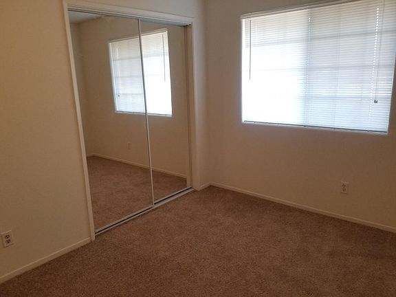 Bedroom 1 with mirror closet doors.