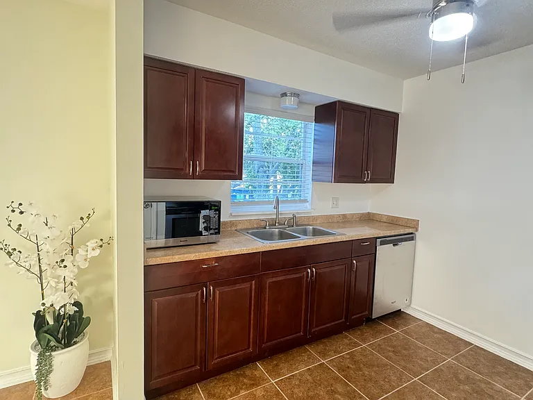 The kitchen is thoughtfully designed with stainless steel appliances, highlighted by a brand-new range hood that adds both style and functionality.