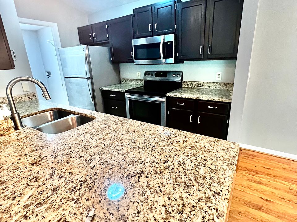 Kitchen with Granite and stainless Steel appliances. Laundry room and panty are attached to the left of this picture