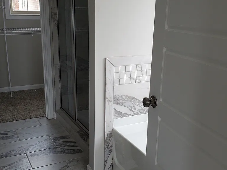 Primary Bedroom Bathroom:
* Tub
* Shower
* 1 of 2 Walk-in Closets