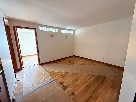 Living room with protective paper on newly refinished hardwood floors
