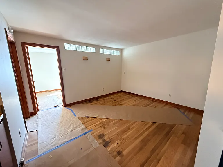 Living room with protective paper on newly refinished hardwood floors