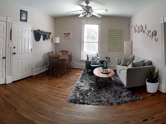 living room view from kitchen area. front bedroom to the left, main bedroom to the right