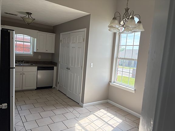 Kitchen, double doors lead to laundry area. Washer and dryer not included.