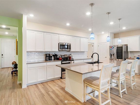 Open floor concept with gorgeous kitchen! Large center island with breakfast bar, stainless appliances, tile work, pantry and plenty of cabinet and counter space!