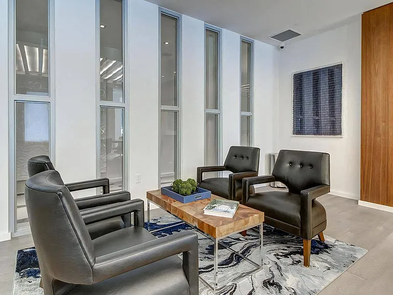 Resident Lounge Featuring Four Armchairs Surrounding a Low Coffee Table