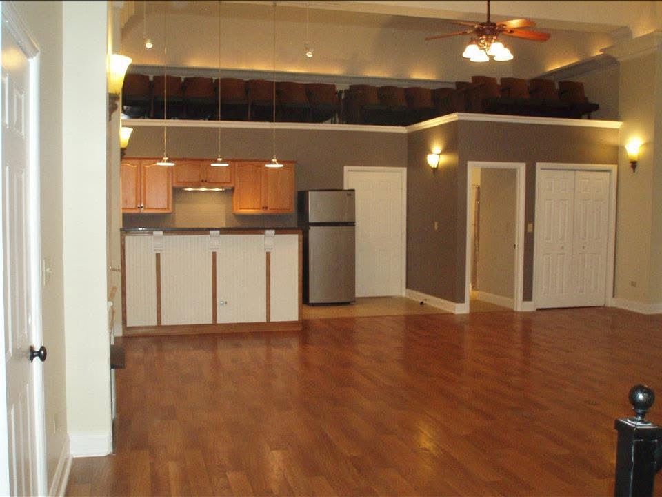 Wide open floor plan with decorative original opera house theater seats lining the east wall of the kitchen.